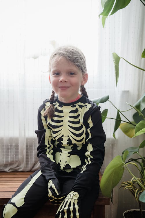 Young kid smiling in skeleton costume