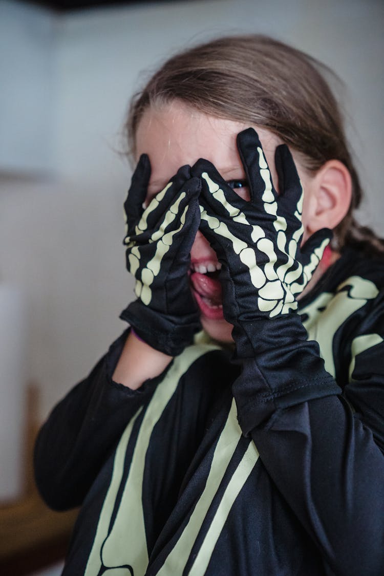 Girl In Skeleton Costume With Head In Hands