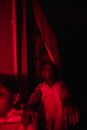 Boys scaring in red-lighted room