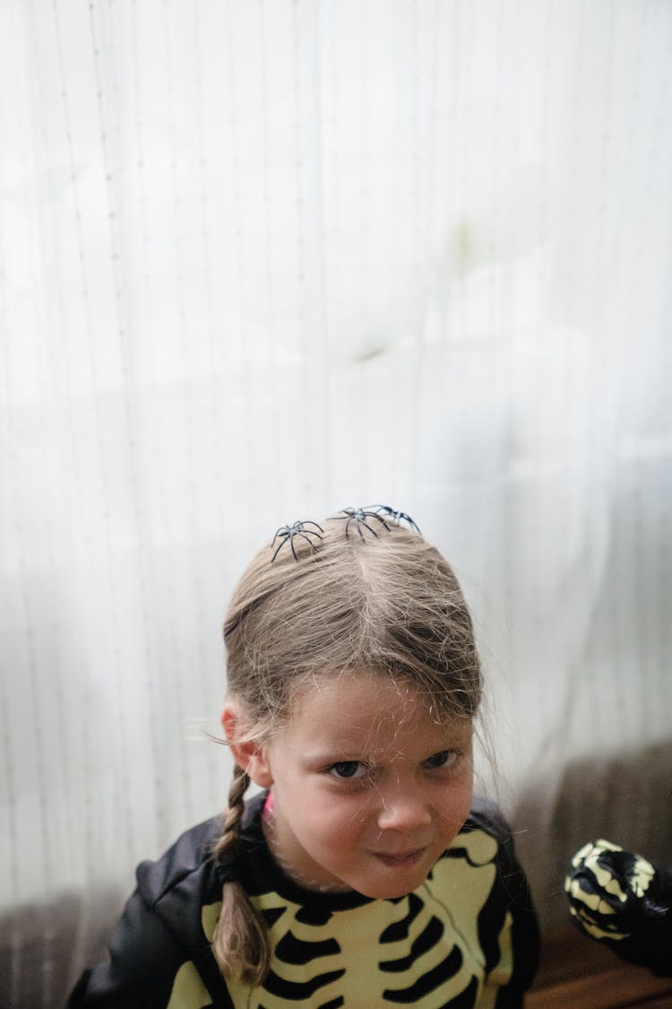 Child Dressed Up As Skeleton Sitting At Home