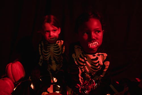 2 children dressed up as skeletons sitting
