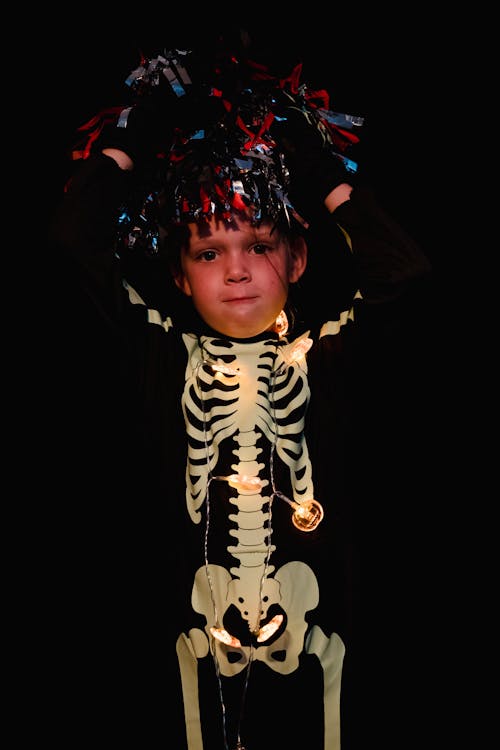 Free Kid wearing skeleton costume and hat made of foil strips Stock Photo