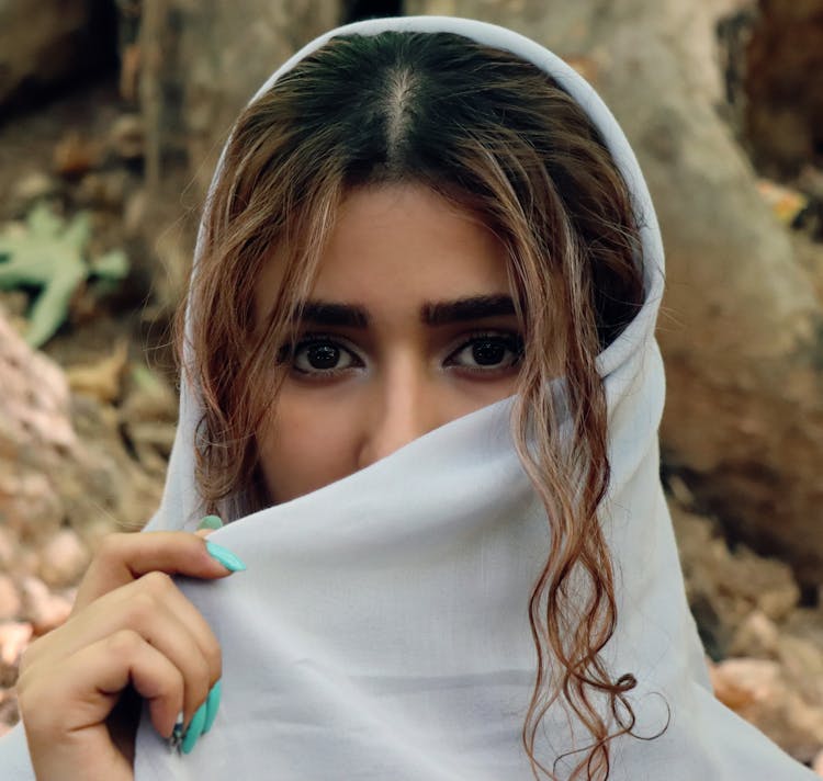 Woman Covering Her Face With White Scarf