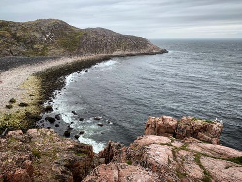 Free Explore the rugged cliffs and serene shoreline of Teriberka, Russia, showcasing nature's raw beauty. Stock Photo