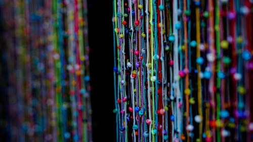 Close-up Photo of Colorful Strings with Beads