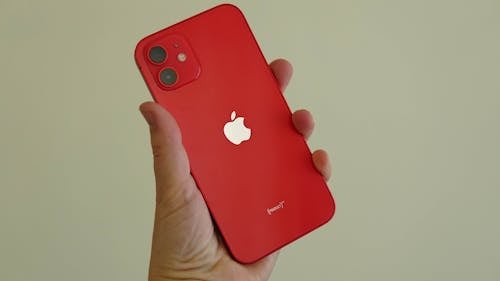 Close-Up Shot of a Person Holding a Red Iphone