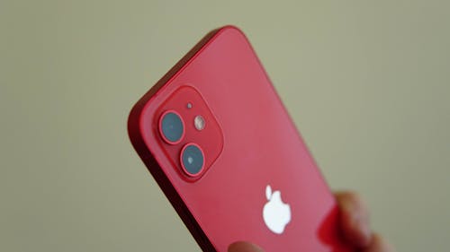 Free Close-Up Shot of a Person Holding a Red Iphone Stock Photo
