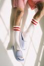 Laying mans legs wearing socks and flip-flops