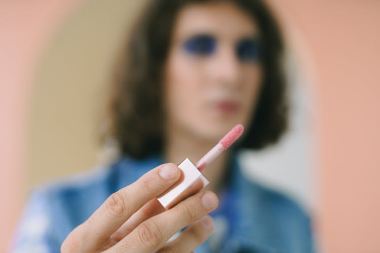 Man Holding Lip Gloss Applicator