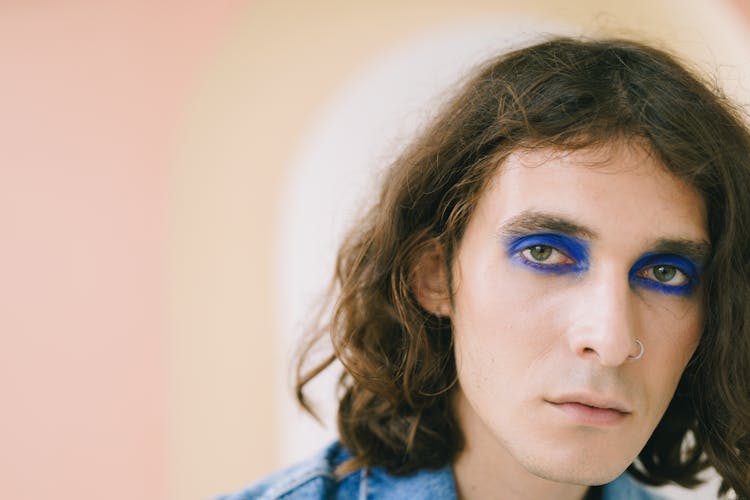 Man Wearing Blue Eyeshadow Looking At Camera