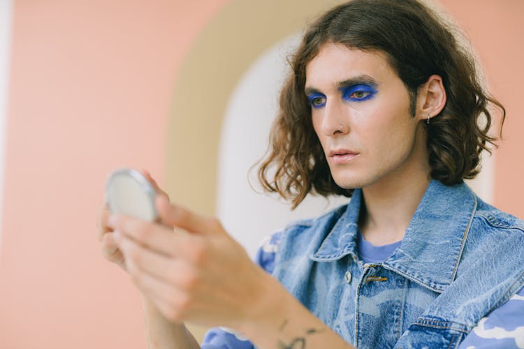 Man Checking Himself In Pocket Mirror