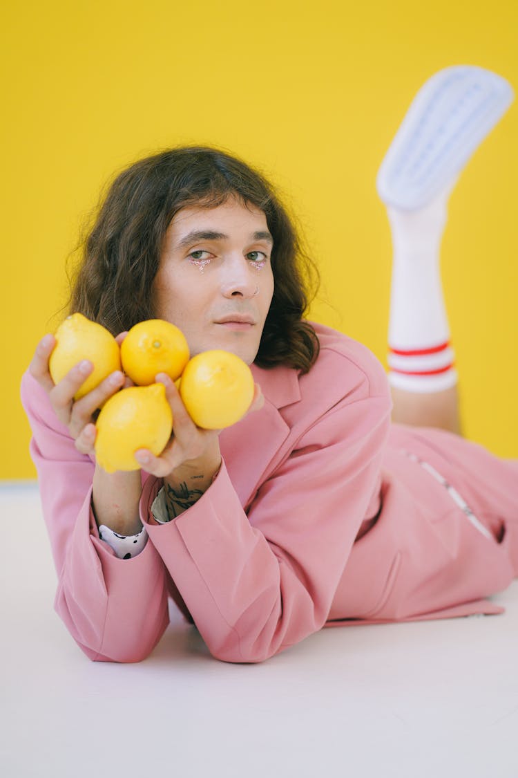 Man In Pink Suit Holding Lemons