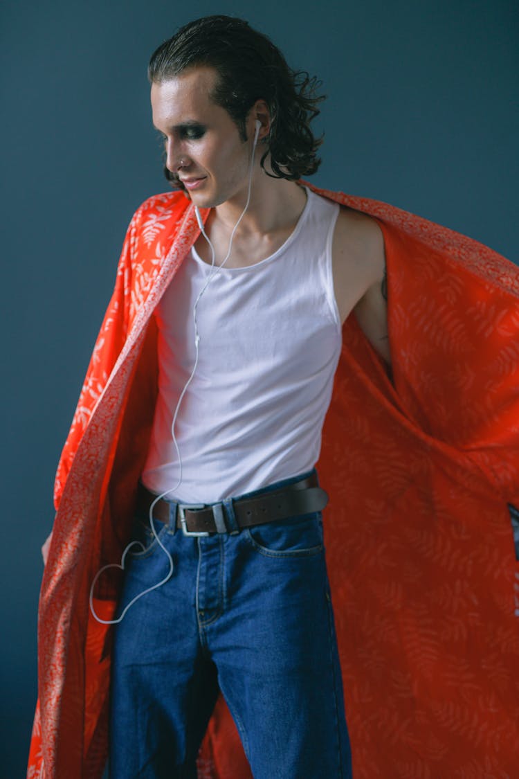 Standing Man With Makeup Wearing Top, Jeans And Red Bathrobe