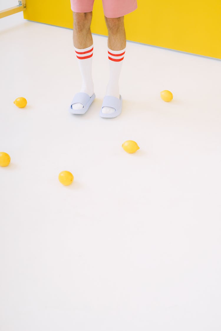 Man Legs In White Socks Surrounded By Lemons