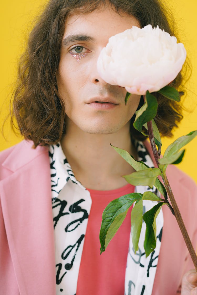 Man In Pink Suit Holding Flower