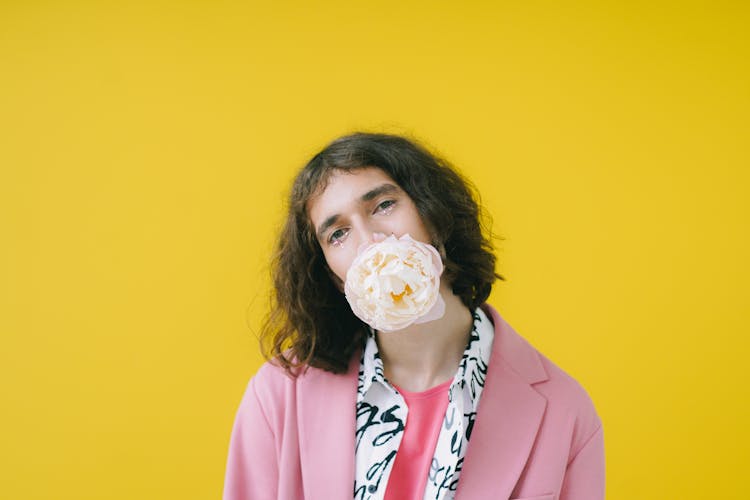 Man In Pink Suit With Flower In His Mouth