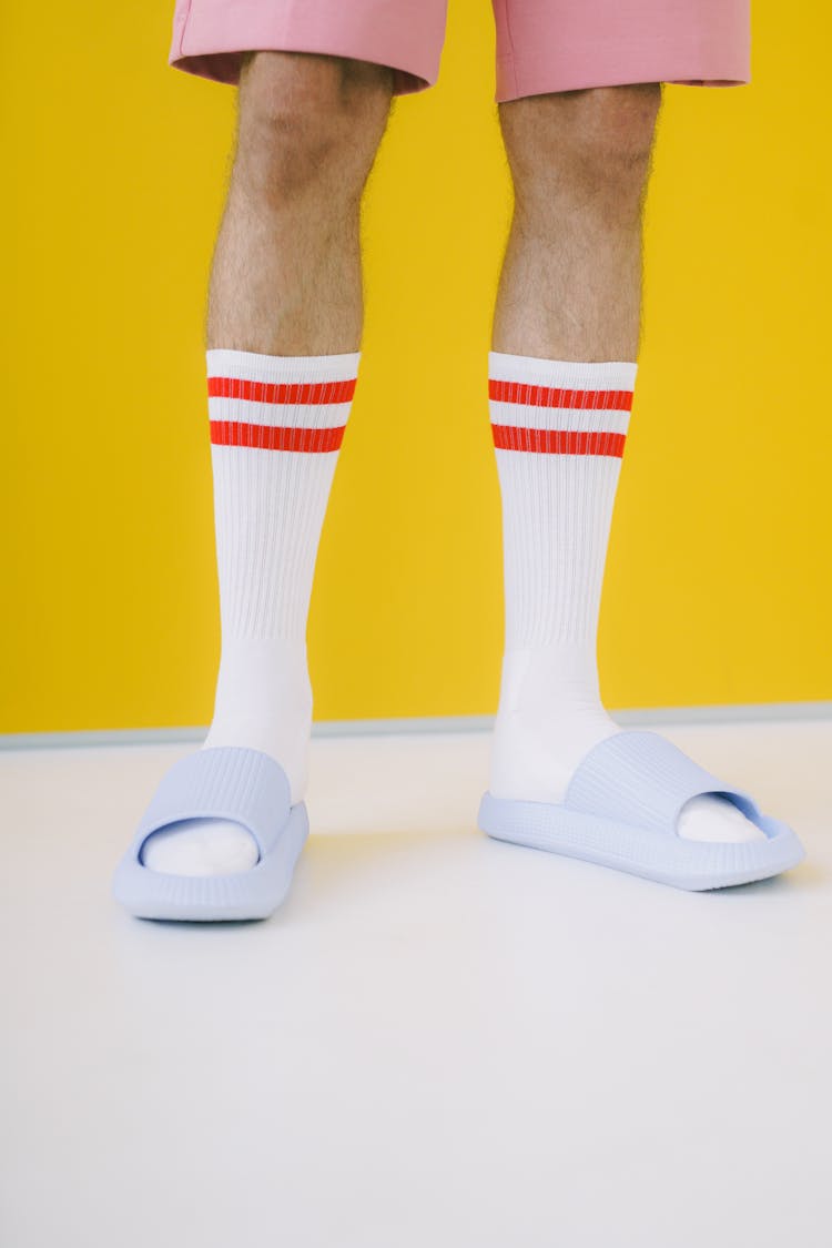 Close Up View Of Man In White Socks And Flip Flops
