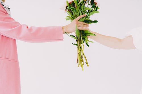 Arms holding bouquet of flowers