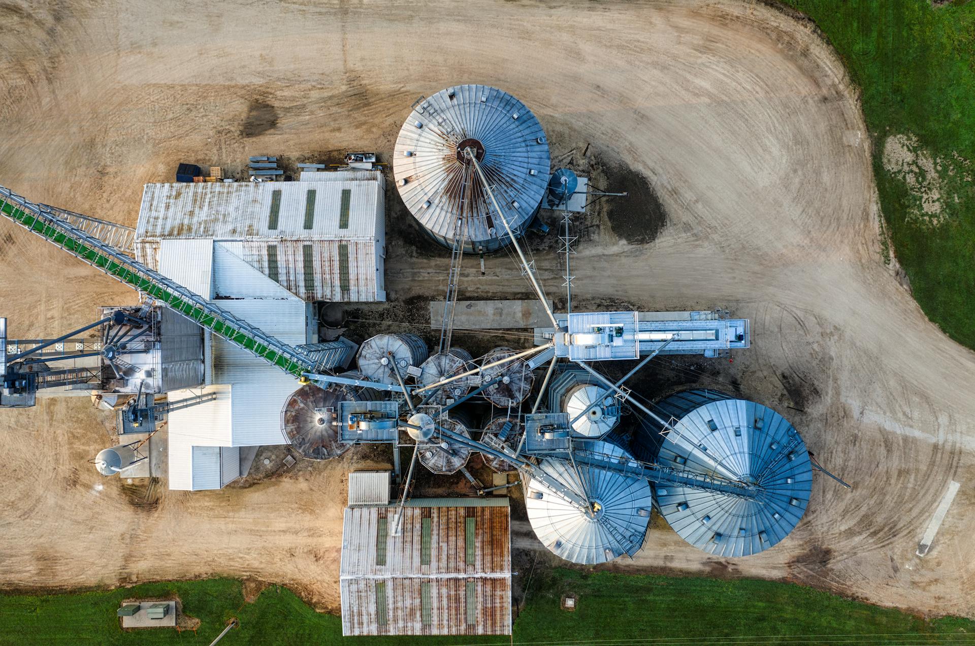 Drone shot capturing the top view of industrial silos and buildings in Utica, MN.