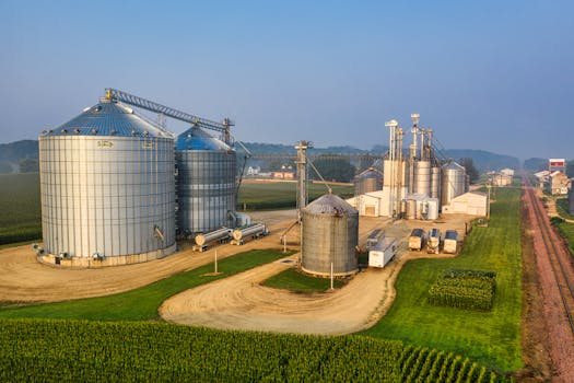 Industrial silos and grain storage facilities at sunrise in Utica, Minnesota.