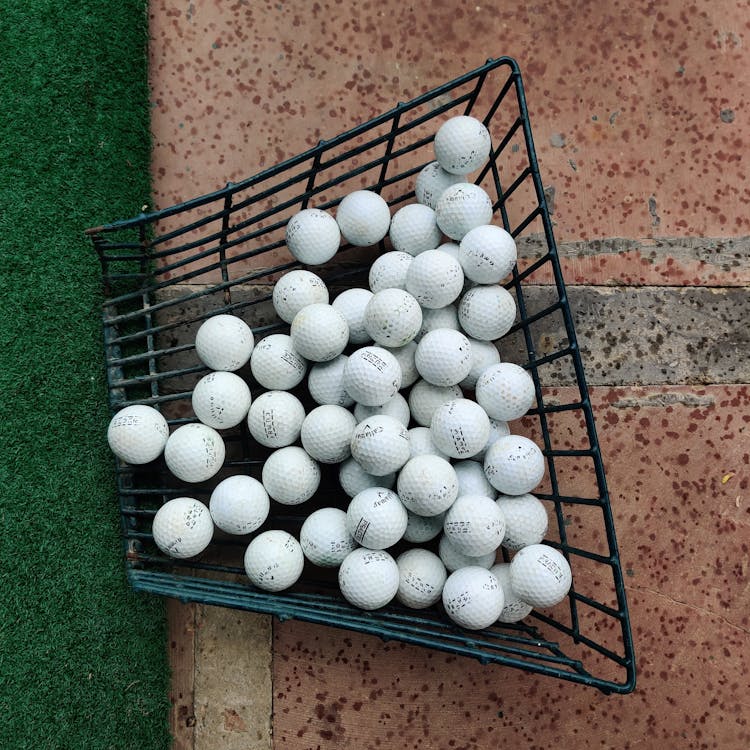 Golf Balls On A Metal Container