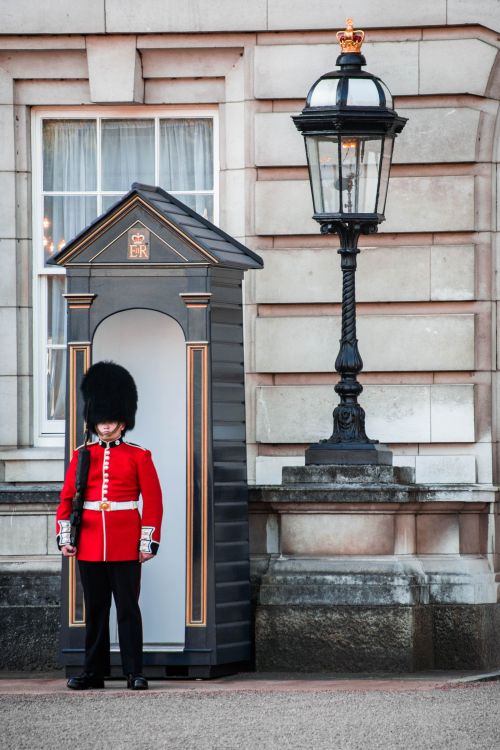 Free Iconic scene of a royal guard at Buckingham Palace, London, showcases traditional British culture. Stock Photo