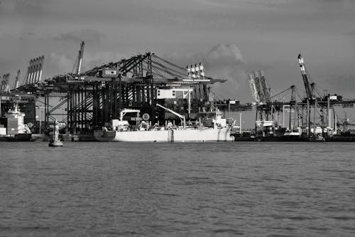 Grayscale Photo of Cargo Ship on Port
