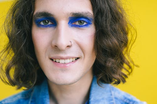 Metrosexual man with blue eye makeup 