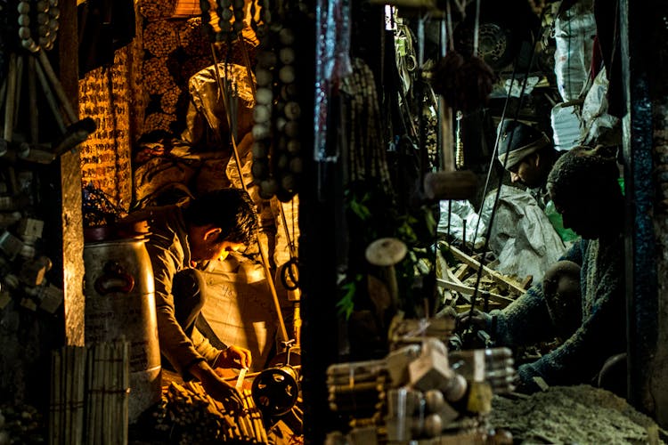 Men Working In Shop At Night