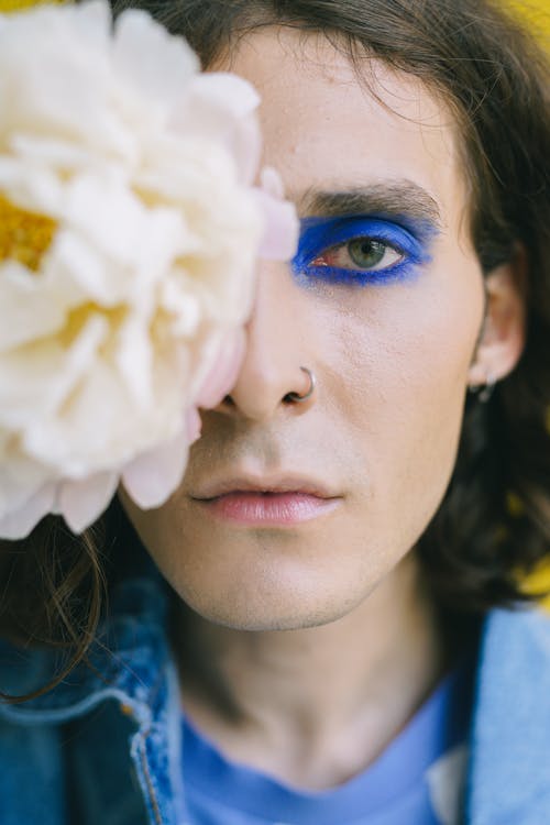Man with Make-up and Flower near his Face
