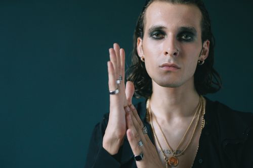 Free Portrait of a person with gothic makeup and multiple accessories expressing a unique style. Stock Photo