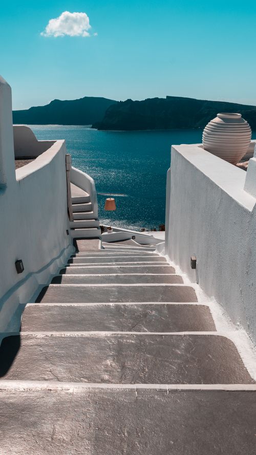 Free A stunning view of white steps leading to the Aegean Sea in Thera, Greece under a clear blue sky. Stock Photo