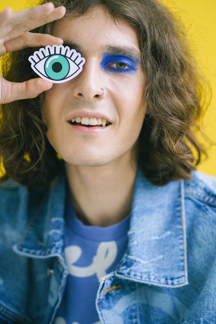 A Man Holding An Eye Cutout