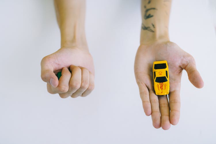 A Person Holding A Toy Car