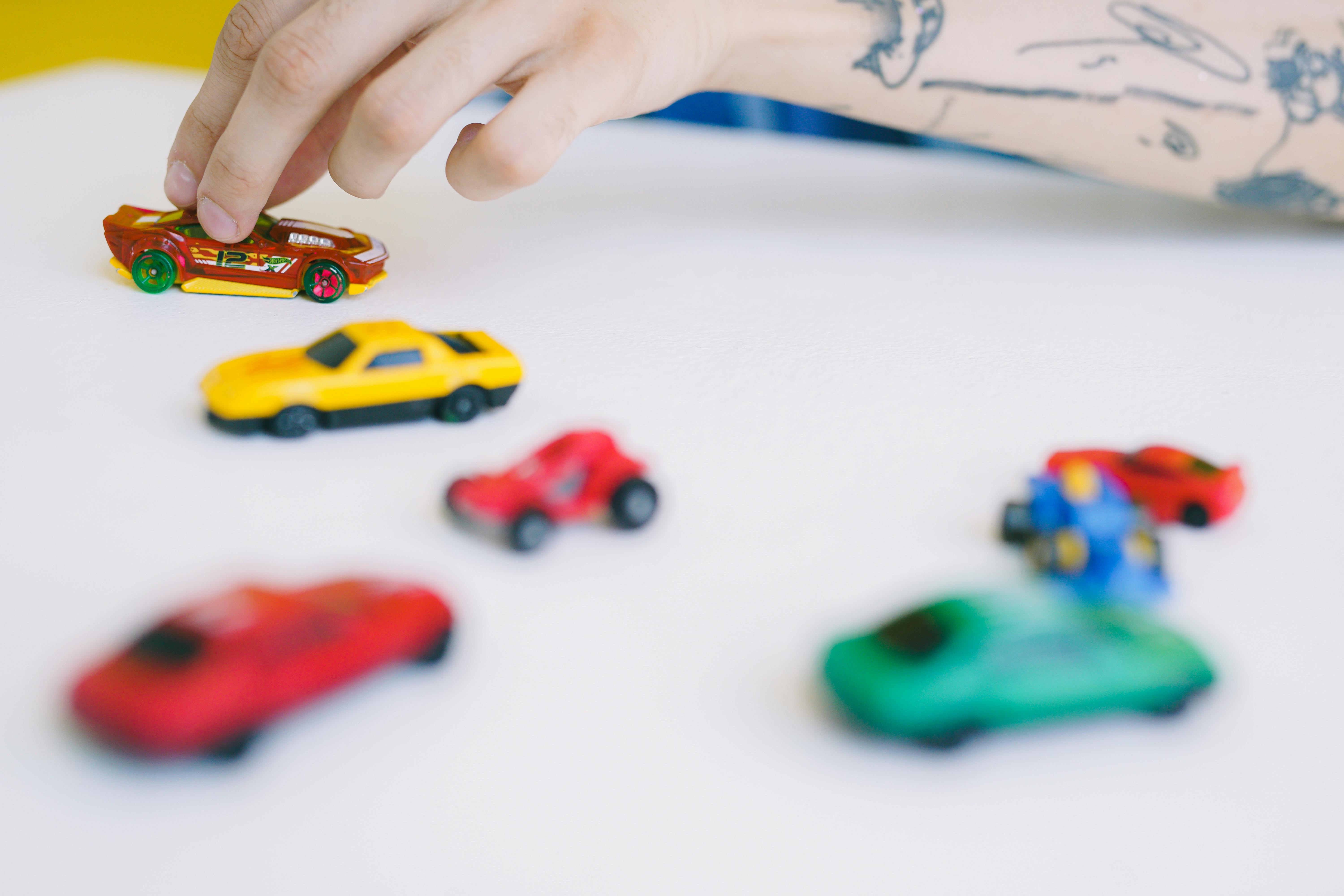 a person playing toy cars