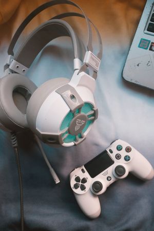 Gaming headphones next to a game controller