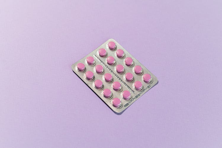 Pink Medicine Tablets On White Surface