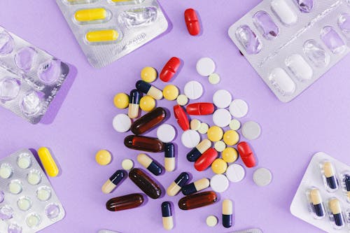 Assorted Pills on Purple Surface