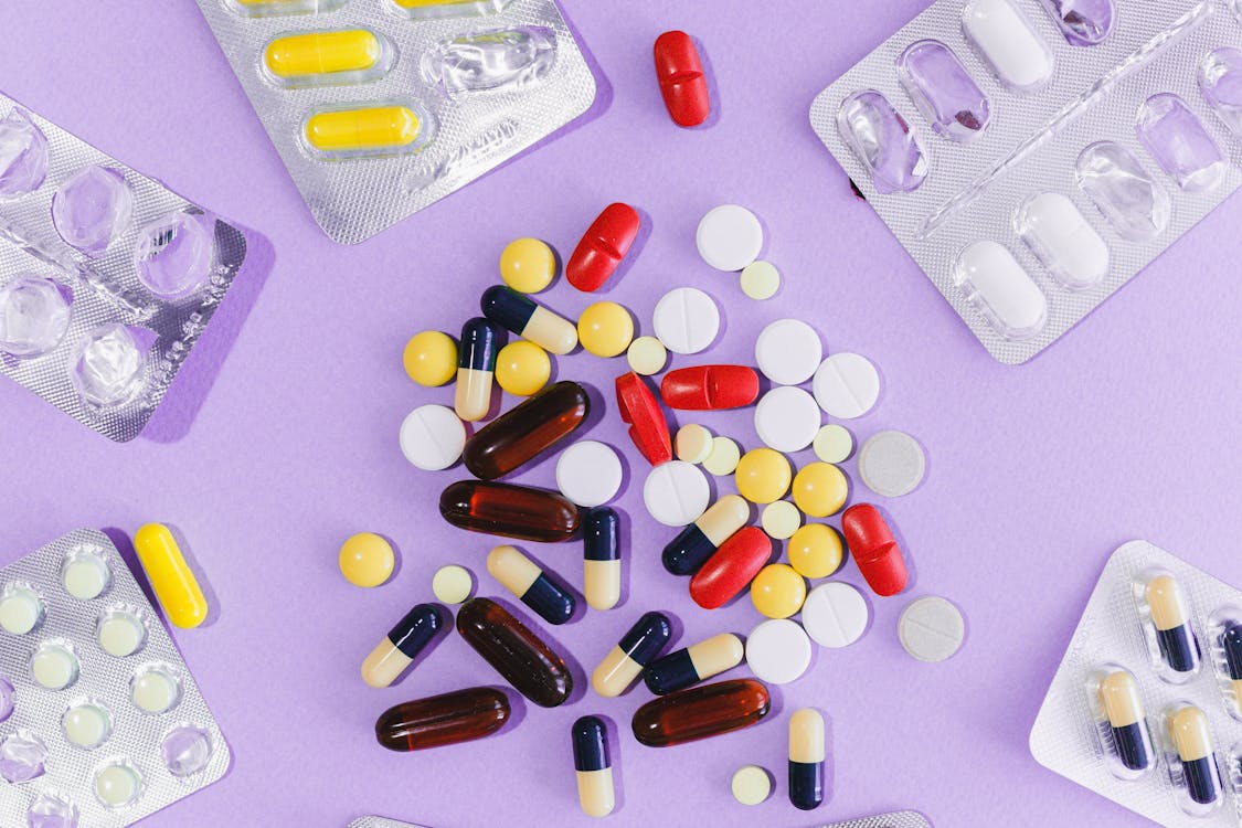Free Assorted Pills on Purple Surface Stock Photo