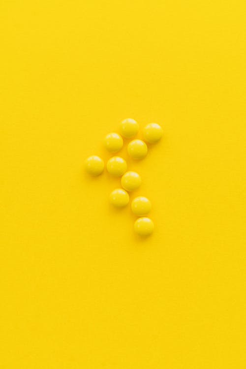 Yellow Pills on Yellow Surface