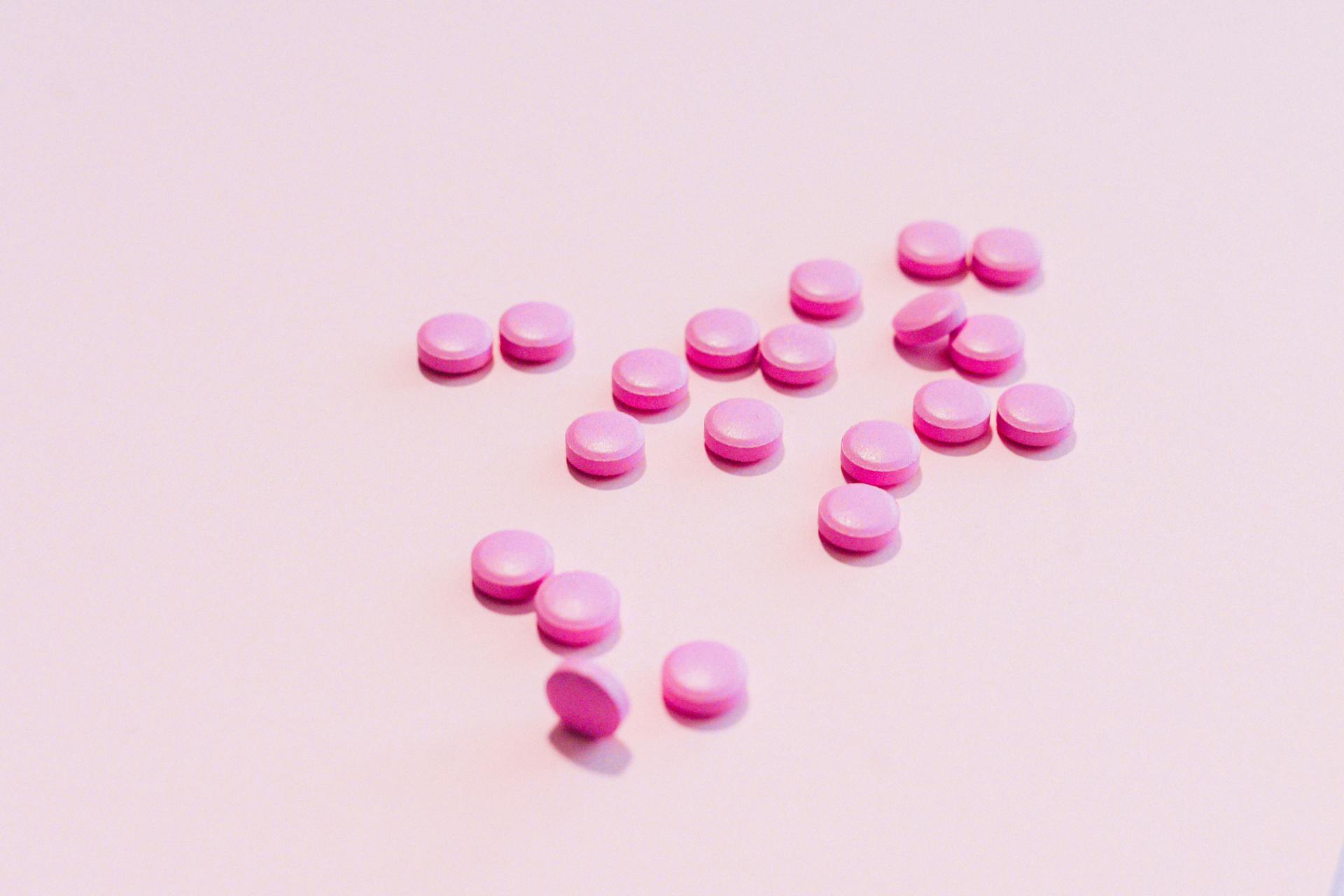 Pink Medication Pill on White Surface