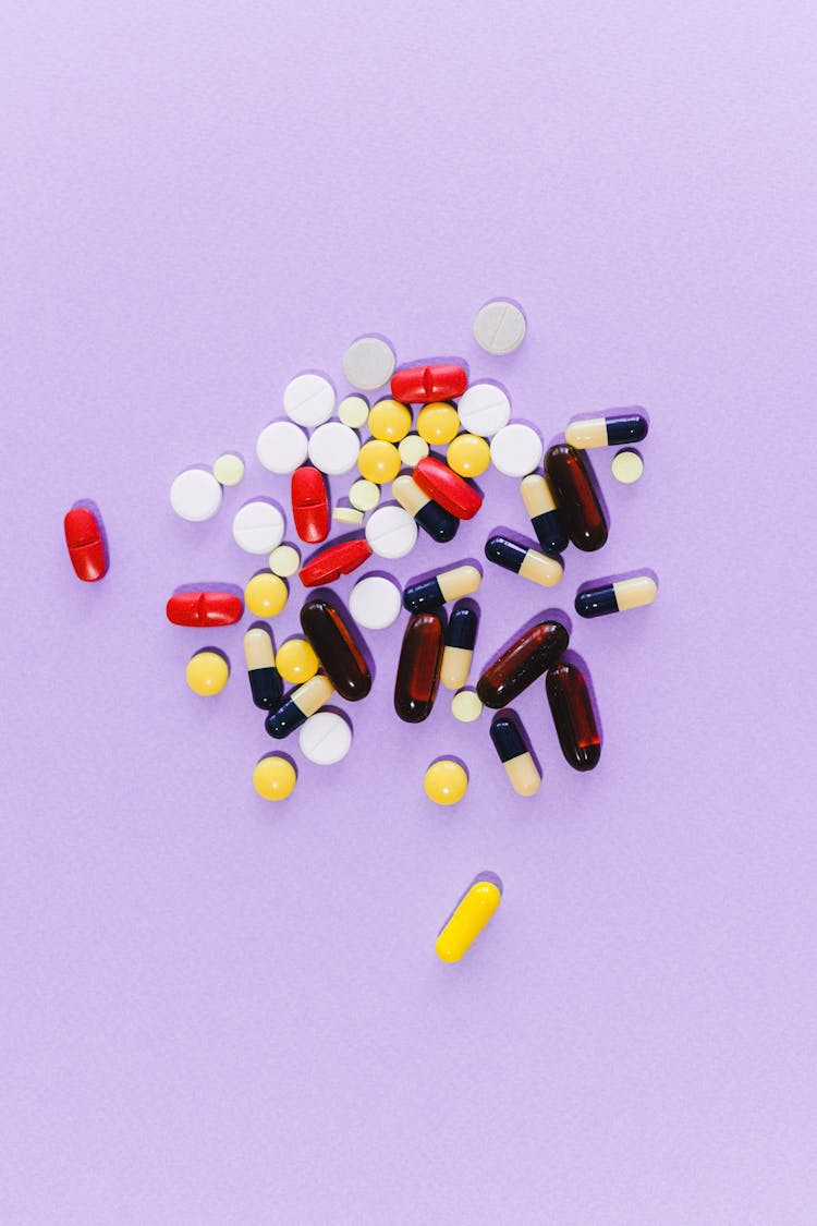 Assorted Medicines On Purple Surface