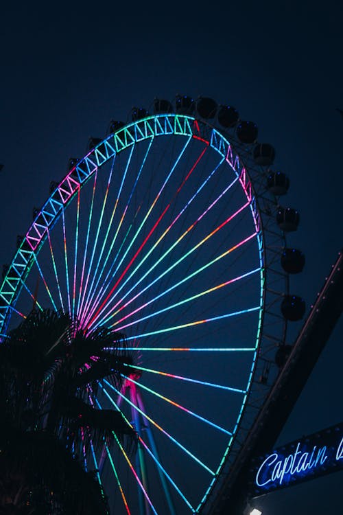 A Ferris Wheel with Neon Lights During Night Time