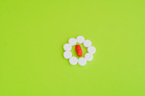 Medicine Tablets on Green Surface