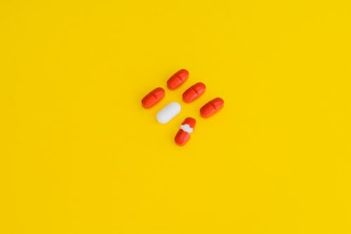 Medicine Tablets on Yellow Surface