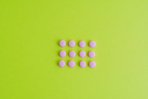 Pink Pills on Green Surface