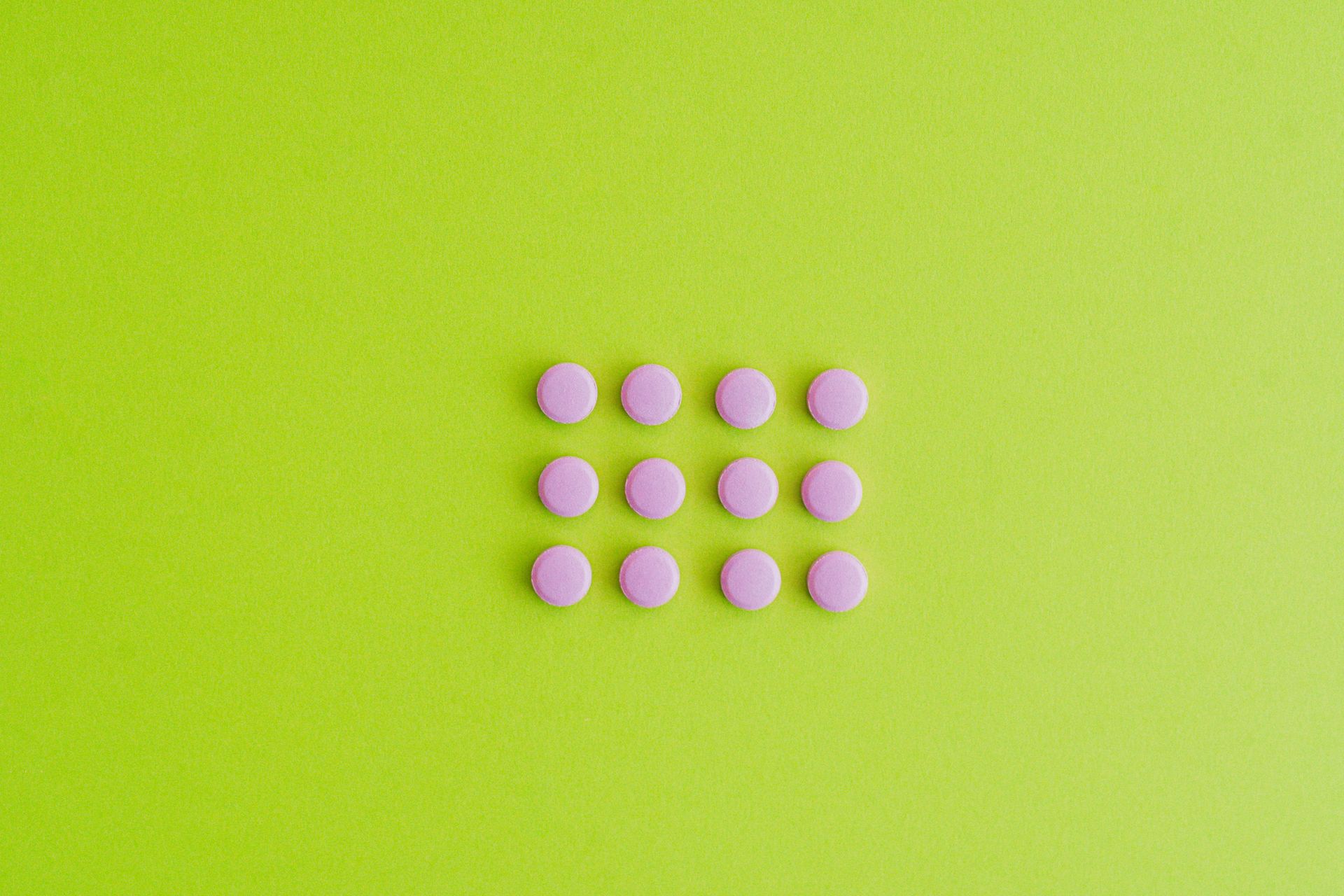 Pink Pills on Green Surface