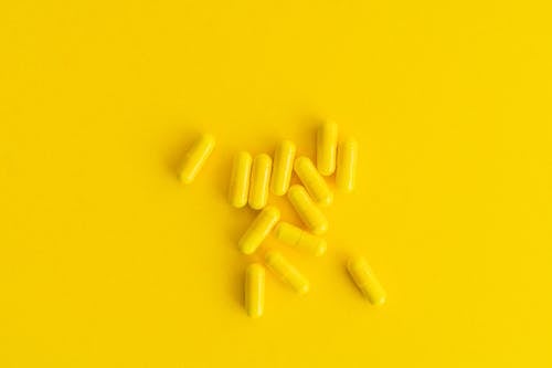 Yellow Capsules on a Yellow Surface