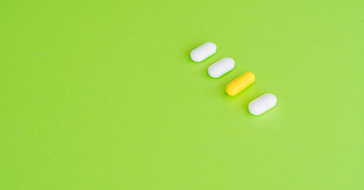 Supplement capsules and a glass of water