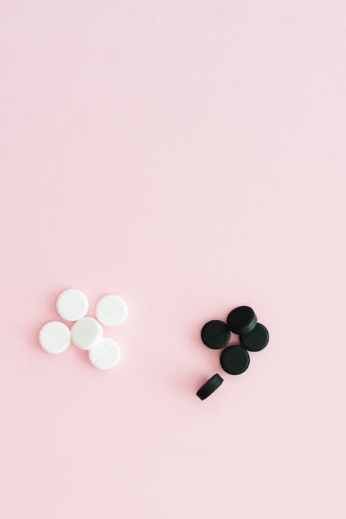 Medicine Tablets on Pink Surface